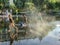 Children run through plaza fountain in Nice, France