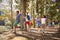 Children Running Ahead Of Parents On Family Hiking Adventure