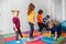 Children running and jumping around multicolor hoops on a floor