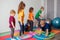 Children running and jumping around multicolor hoops on a floor