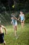 Children running through lawn sprinkler