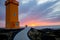 Children running on a path to lighthouse in lava field in beautiful nature in Snaefellsjokull National Park in Iceland, autumntime