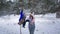 children's activities in the winter, an adorable boy has fun with his mother on a swing among trees during snowy