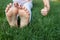 Children\\\'s bare feet on green grass. cheerful positive atmosphere