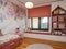 Children's bedroom interior decorated in pink and white colour scheme with a inviting window seat