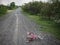 Children`s bikecycle and shoe on stone road. missing children co