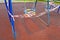 Children\\\'s blue swing on a sports playground in the park wrapped with red barrier tape