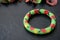 Children`s bracelet with the image of ladybugs on a dark background