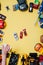 Children`s cars toys for developing baby games on a yellow background