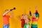 Children`s choir accompanied by clarinet. The boy plays the clarinet to the children, and they sing and raise their hands up
