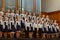 Children`s choir and soloists on stage before the start of the performance.