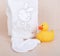 Children`s clothing diapers pajamas mittens socks vests sliders white background and ruber toy yellow duck