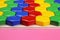 Children`s Color puzzle, honeycomb mosaic on a pink background