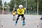 Children`s competition in roller sport.The girl jumps on rollers through a barbell