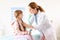 Children`s doctor examining little girl in hospital