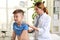 Children`s doctor examining patient with stethoscope