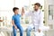 Children`s doctor giving high five to patient