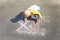 Children`s drawing with chalk on the asphalt, family with no dad. Son crossed out father. Family divorce topic