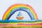Children`s drawing depicting a beautiful rainbow and boat.