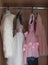 Children `s dress-up dresses on a hanger, children `s things, outfits for little ones