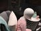 Children`s dummy in clothes. Children`s mannequin, dressed in a pink sweater, sitting on a chair, side view. No trademarks or