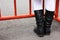 Children`s feet are on the asphalt in front of a metal fence. Pedestrian traffic is prohibited