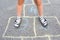 Children`s feet close-up on the pavement. View from above. Outdoor games