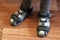 Children`s feet in sport sandals on laminate flooring