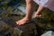 Children`s feet in the water. spray feet from the water