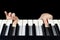 Children`s fingers press the piano keys