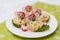 Children`s food, funny tartlets in the form of animals. Children`s menu on a green background.