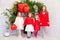 Children`s friends sit with red balloons at the holiday birthday