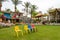 The children`s garden with colorful chairs and flowers in hotel Seagull Beach Resort