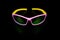 Children`s glasses for cycling and sports. Made of pink plastic with yellow temples and UV-resistant lenses. Photographed on a