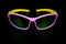 Children`s glasses for cycling and sports. Made of pink plastic with yellow temples and UV-resistant lenses. Photographed on a