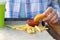 Children`s hand holds chicken nuggets and dips it in ketchup, next to it lies french fries