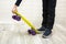 children& x27;s hand lifts the skate by stepping on it with their foot