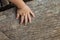 Children\'s hand is located on an old stump