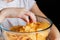 Children`s hand takes chips out of glass bowls, harmful food