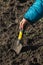 Children`s hand working with a garden spatula