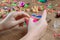 Children`s hands closeup weaving crafts from colored rubbers, education and entertainment