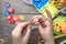 Children`s hands closeup weaving crafts from colored rubbers, education and entertainment