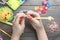 Children`s hands closeup weaving crafts from colored rubbers, education and entertainment