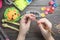 Children`s hands closeup weaving crafts from colored rubbers, education and entertainment