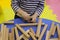 Children`s hands collect a wooden constructor. children`s puzzle puzzle of wooden parts. child plays and develops with wooden el