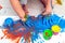 Children`s hands and feet in blue paint. finger paints. Baby artwork