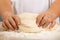 Children`s hands and the hands of his mother and knead dough tog