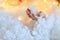 Children`s hands holding artificial snow or fluff on the background of magic lights. Very soft selective gentle focus.