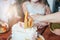 Children& x27;s hands little girls reach for the cake. Big beautiful cake unicorn on the ten years birthday of little Princess on