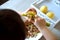 Children s hands peeling potatoes with montessori materials for a lesson from the practical life zone. peeler, potatoes, plate,